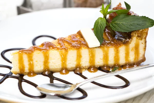 Piece of cheese cake on a table in a restaurant — Stock Photo, Image