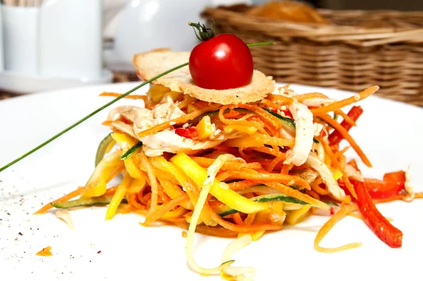 Salad of steamed vegetables on a white plate in a restaurant — Stock Photo, Image