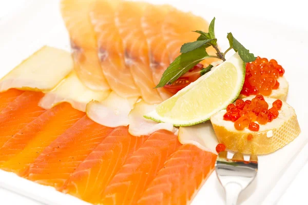 Sandwiches with caviar and sliced fish on a white plate — Stock Photo, Image