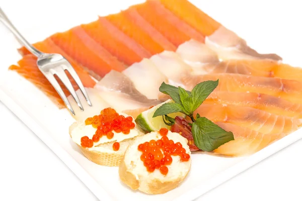 Sandwiches with caviar and sliced fish on a white plate — Stock Photo, Image