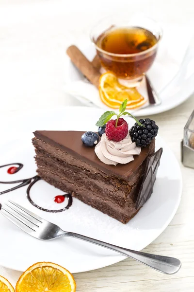 Dessert, a piece of cake on the table with a cup of tea — Stock Photo, Image