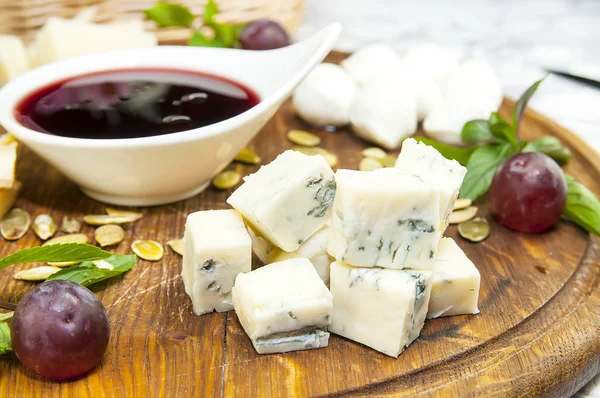 Cheese plate with a large decorated the assortment of mint — Stock Photo, Image