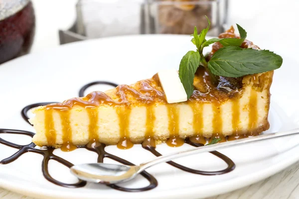 A piece of cheese cake decorated with mint — Stock Photo, Image