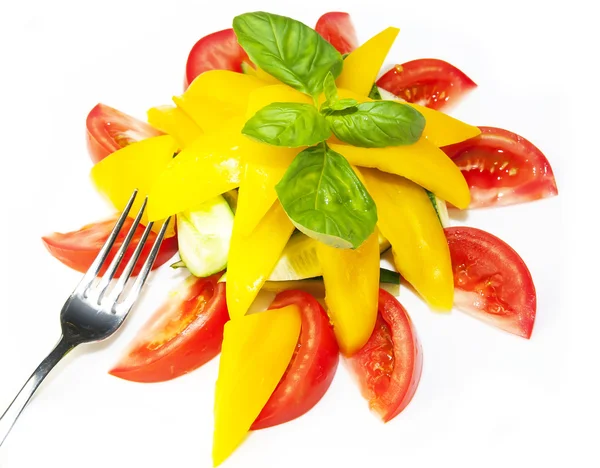 Tomatoes and peppers sliced on a white plate — Stock Photo, Image