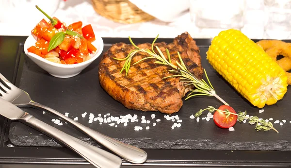 Grilled steak with sauce and greens — Stock Photo, Image