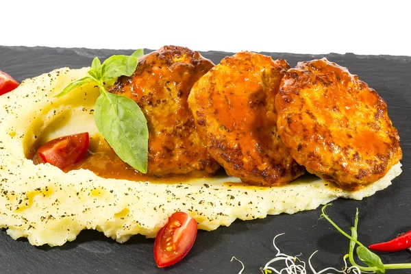 Cutlets fried in carrot sauce with mashed potatoes — Stock Photo, Image