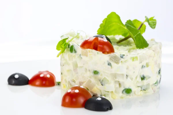 Olivier salad decorated with tomato in the shape of ladybug — Stock Photo, Image