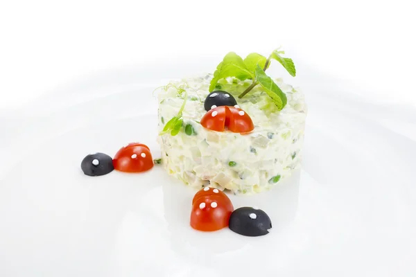 Olivier salad decorated with tomato in the shape of ladybug — Stock Photo, Image