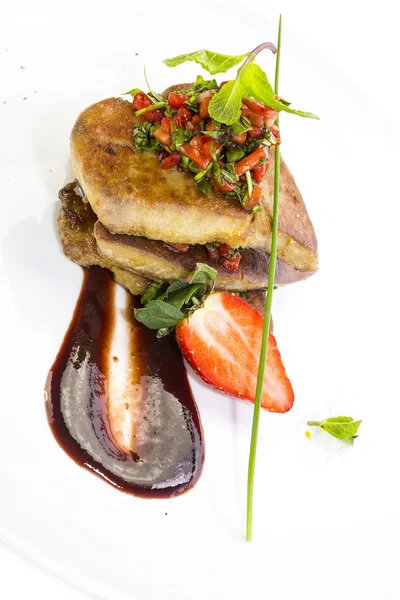 Roast goose liver is decorated with greens and strawberries — Stock Photo, Image