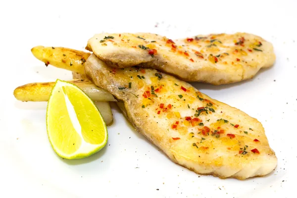 Sturgeon steak cooking on the grill with lemon and sauce — Stock Photo, Image