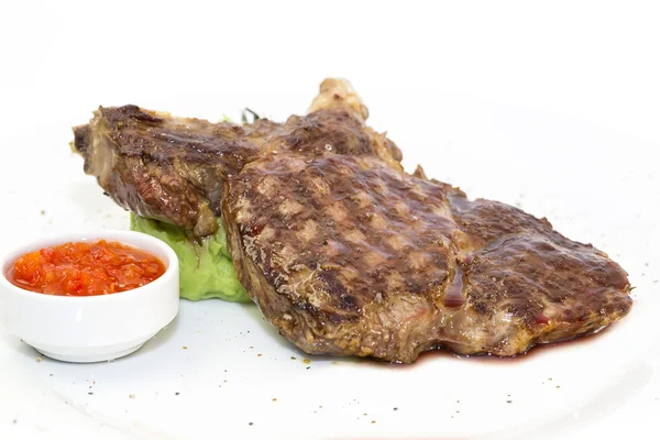 Grilling steak with tomato sauce — Stock Photo, Image