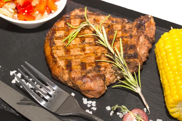 Grilled steak with sauce and greens — Stock Photo, Image