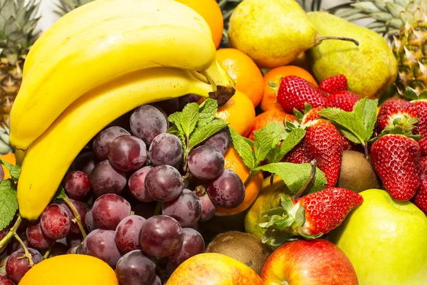 Background of ripe fruit apples oranges grapes — Stock Photo, Image