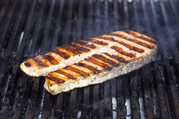 Cooking steak grilled salmon in the kitchen — Stock Photo, Image