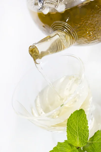 Tea poured from a teapot on a white background — Stock Photo, Image