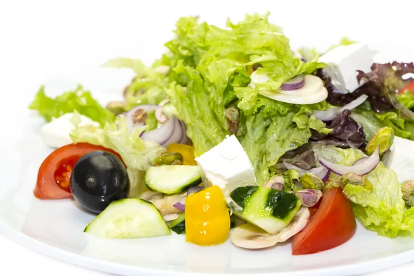 Salad with cheese tomatoes and greens — Stock Photo, Image