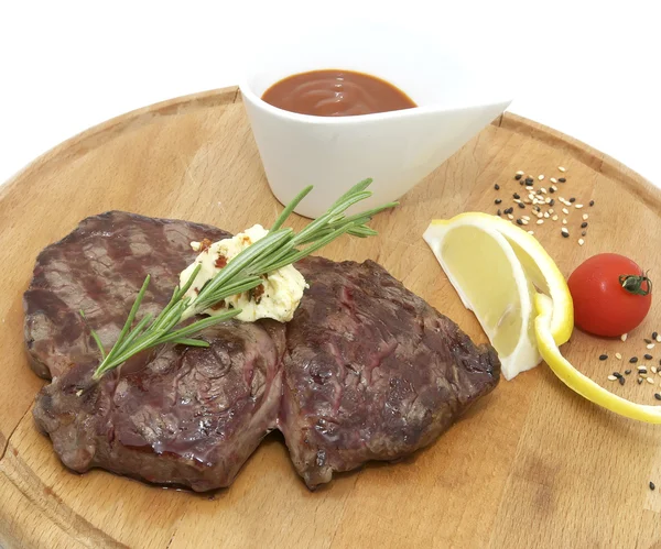 Steak grilled with lemon and tomato sauce — Stock Photo, Image