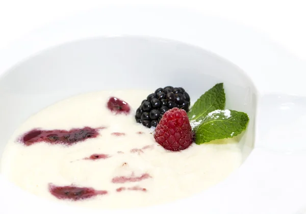 Semolina porridge with berries decorated with berry jam — Stock Photo, Image