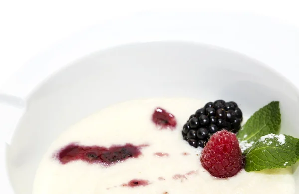 Semolina porridge with berries decorated with berry jam — Stock Photo, Image