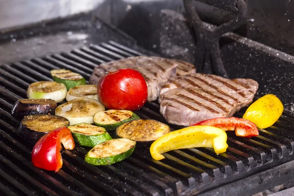Cooking beef steak on a grill — Stock Photo, Image