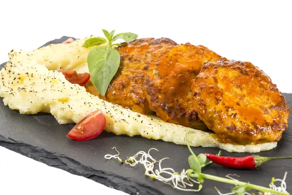 Cutlets fried in carrot sauce with mashed potatoes — Stock Photo, Image