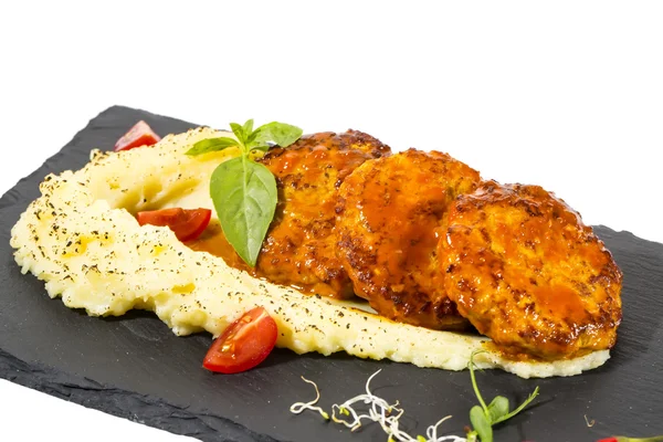 Cutlets fried in carrot sauce with mashed potatoes — Stock Photo, Image