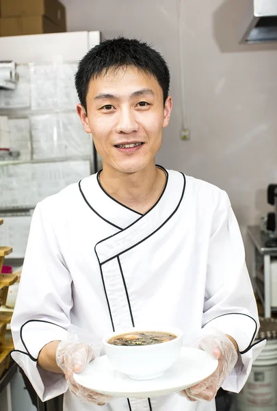 Japanese chef with a plate of sushi — Stock Photo, Image