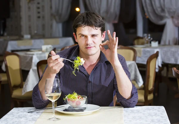 Young man having dinner — Stock Photo, Image