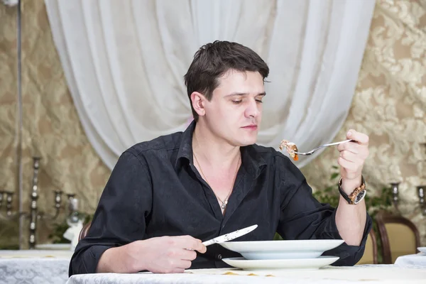 Young man having dinner — Stock Photo, Image