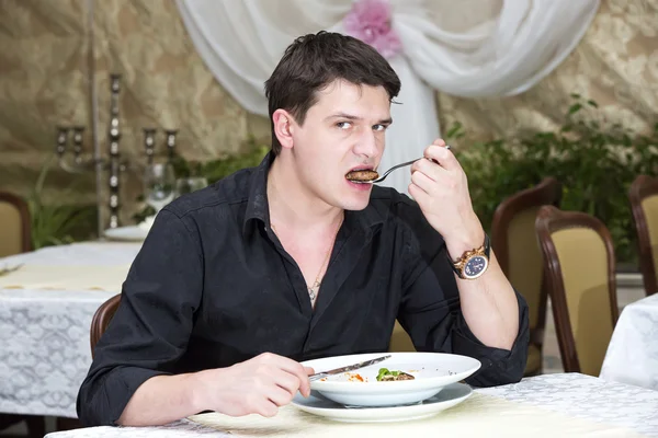 Young man having dinner — Stock Photo, Image