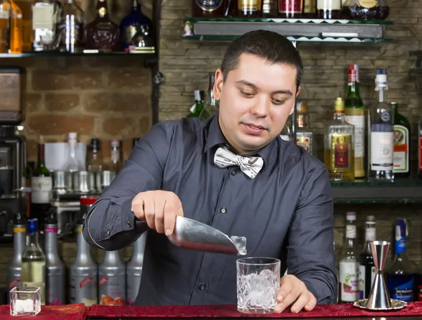 Young man working as a bartender — Stock Photo, Image