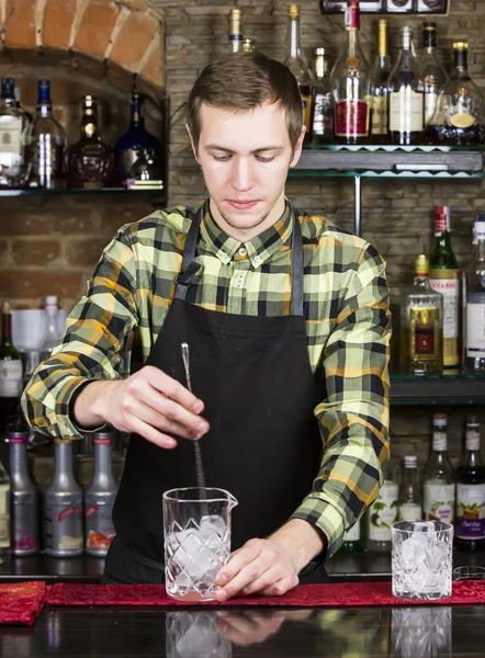 Young man working as a bartender — Stock Photo, Image