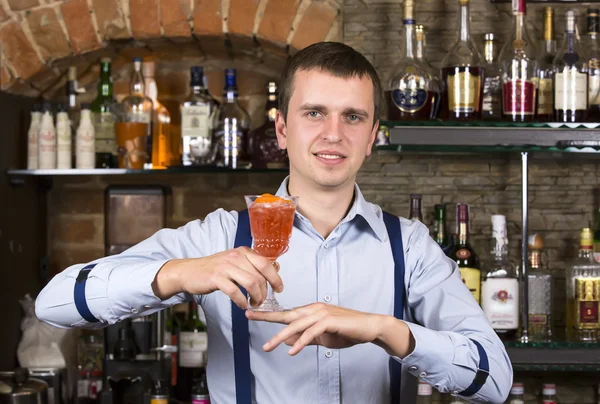 Young man working as a bartender — Stock Photo, Image