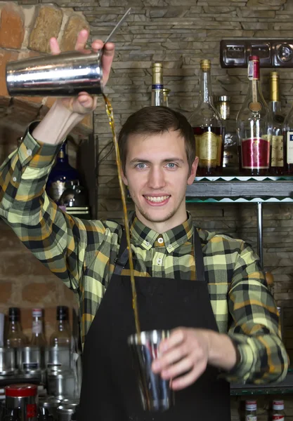 Young man working as a bartender — Stock Photo, Image