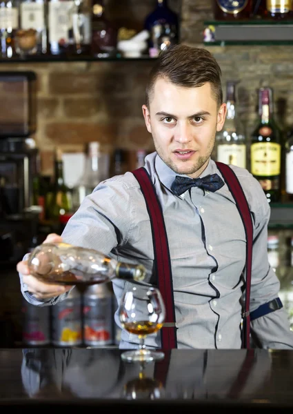 Young man working as a bartender — Stock Photo, Image