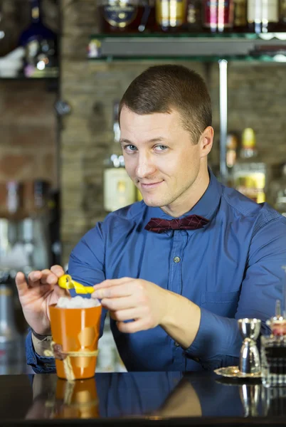 Young man working as a bartender — Stock Photo, Image