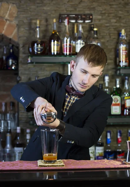 Young man working as a bartender — Stock Photo, Image