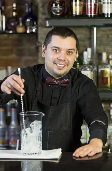 Young man working as a bartender — Stock Photo, Image