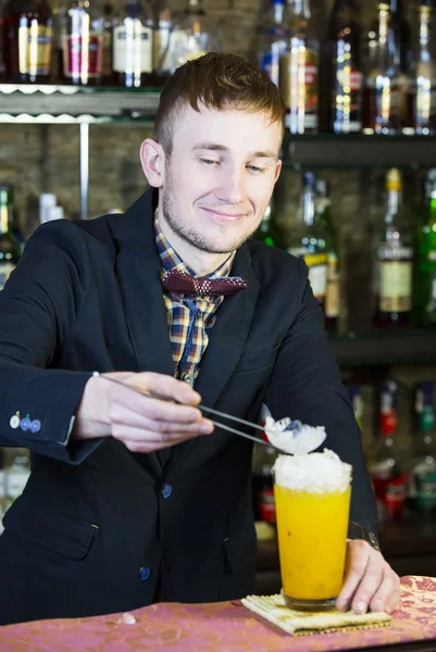 Young man working as a bartender — Stock Photo, Image