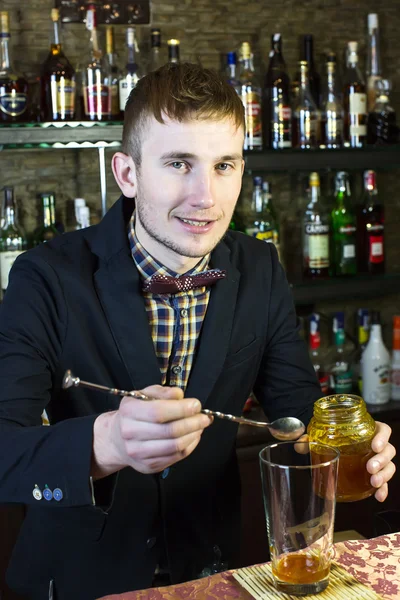 Young man working as a bartender — Stock Photo, Image