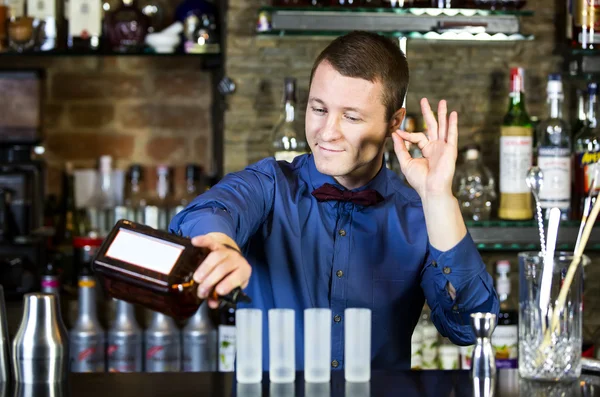 Young man working as a bartender — Stock Photo, Image