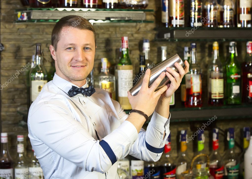 Young man working as a bartender