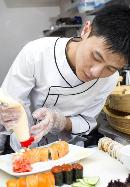 Japanse chef-kok in restaurant maken sushi rolt — Stockfoto