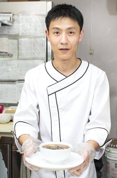 Japanese chef with a plate of sushi — Stock Photo, Image