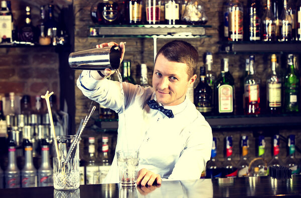 Young man working as a bartender