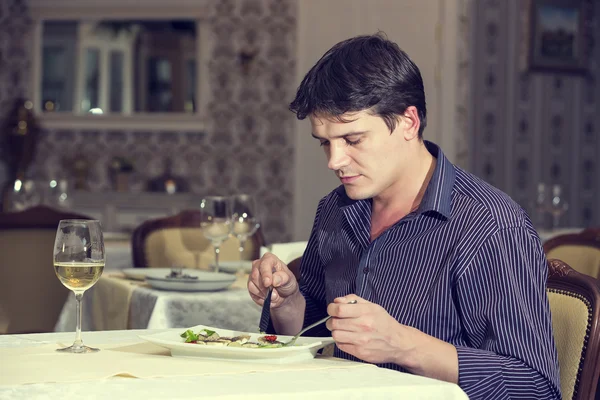 Young man having dinner — Stock Photo, Image