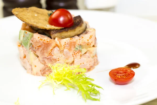 Salad, fish and eggs decorated with greens and tomatoes — Stock Photo, Image