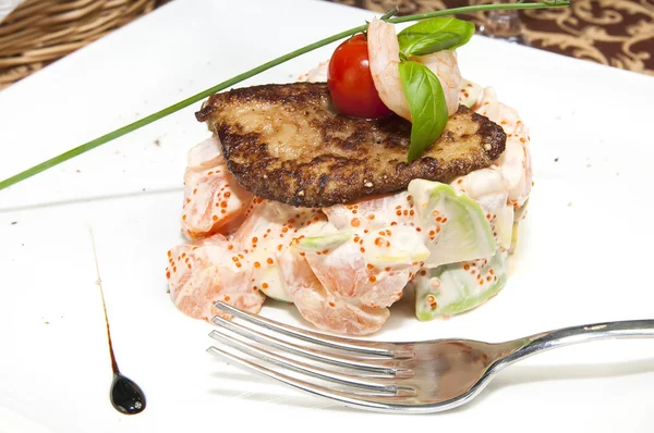 Salad, fish and eggs decorated with greens and tomatoes — Stock Photo, Image