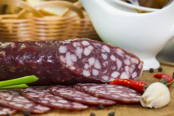 Sausage on a wooden plate — Stock Photo, Image