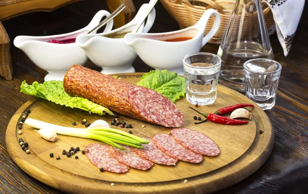 Sausage on a wooden plate — Stock Photo, Image